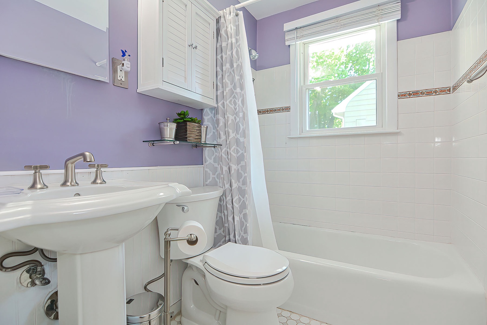 The full bathroom with tub and shower.