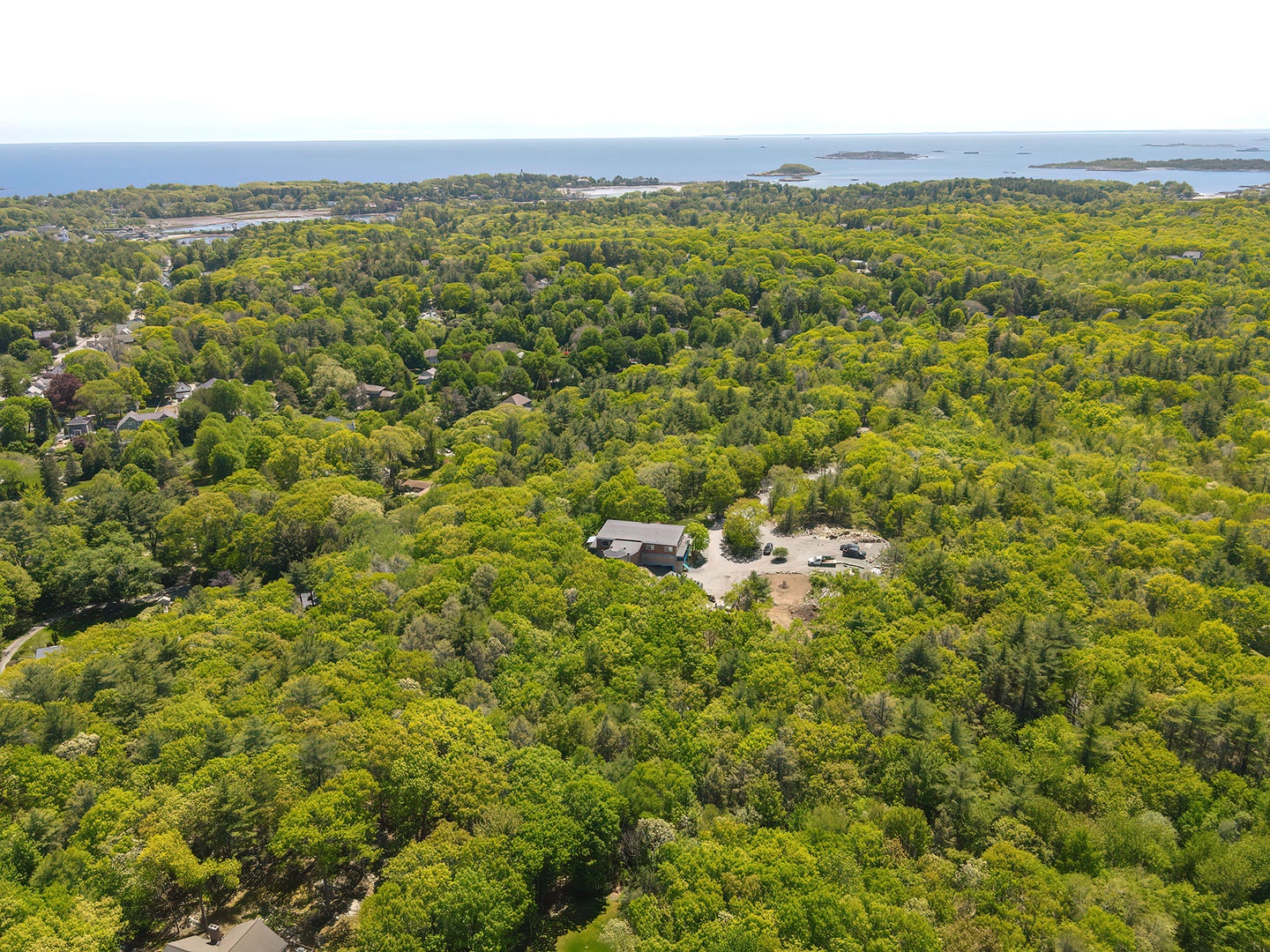 Aerial view of the property, with the sea beyond.