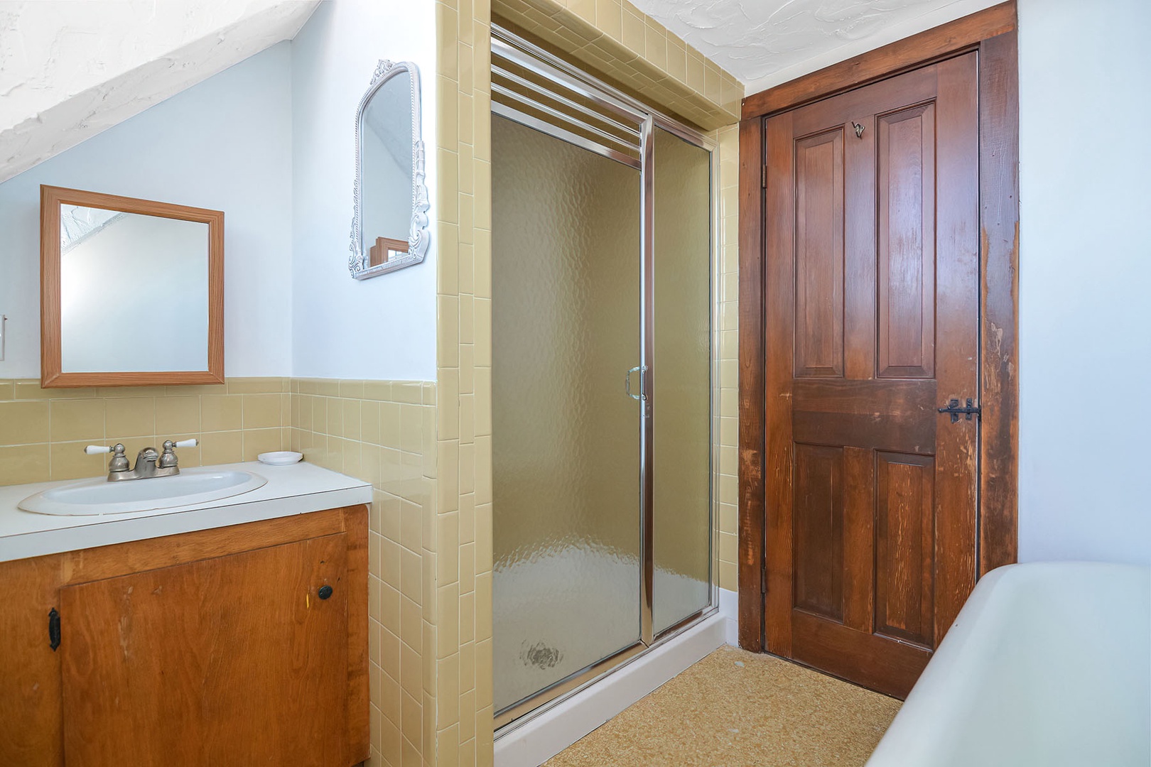 Shared full bath with clawfoot tub and separate shower.