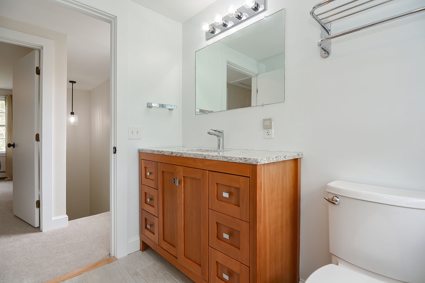 Full bathroom with walk-in shower and cabinet