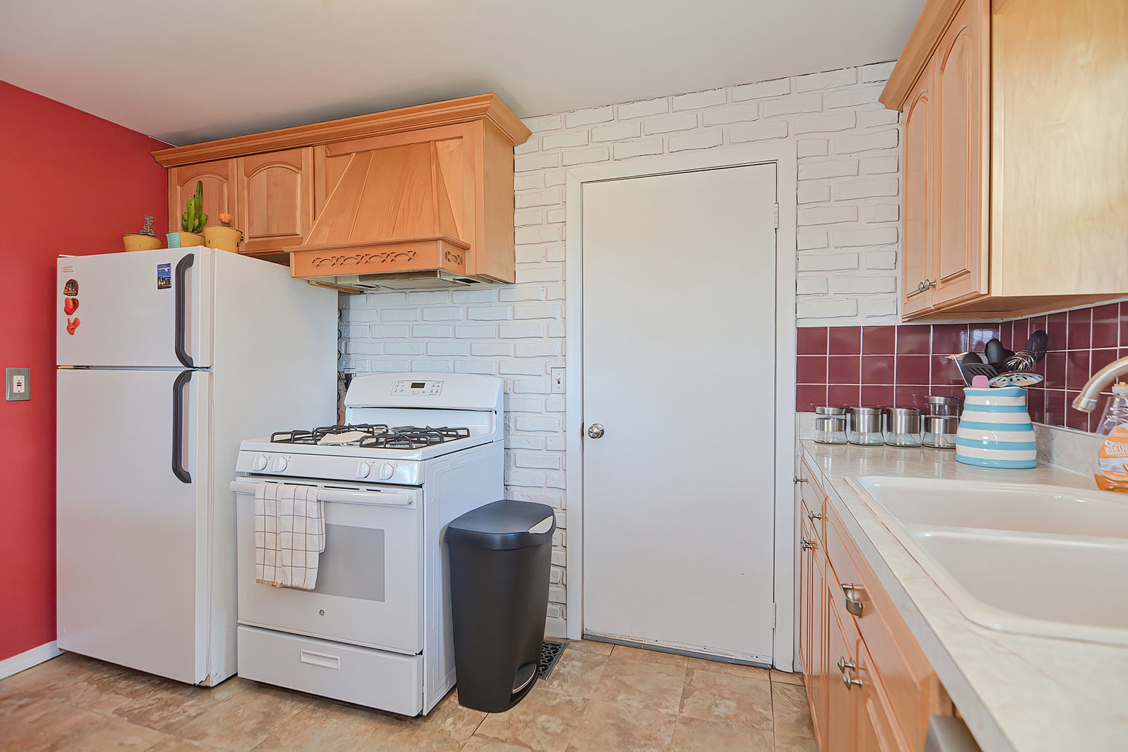 The kitchen includes a gas stove, microwave, and more.