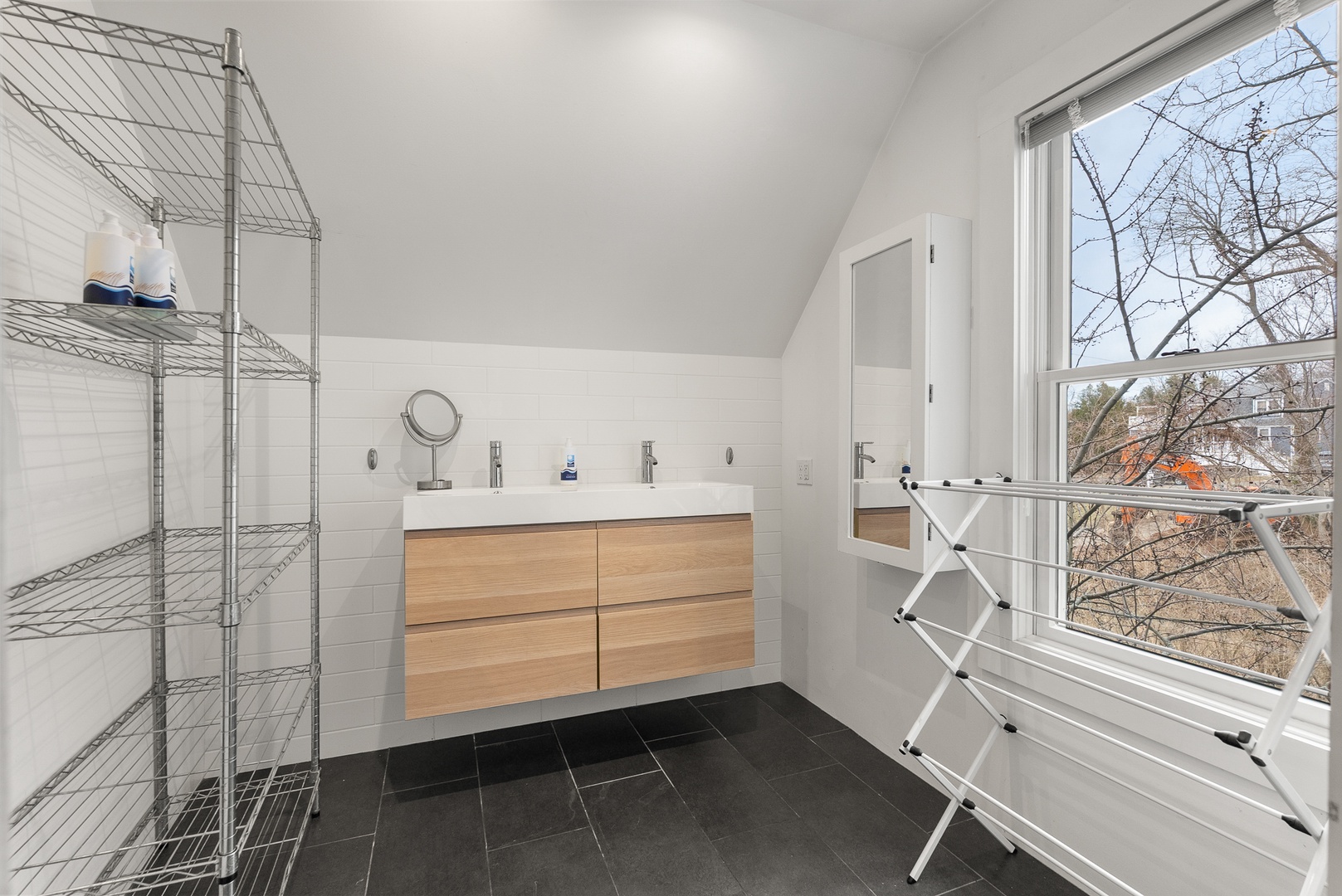 Upstairs is a European-style full bath with walk-in shower.