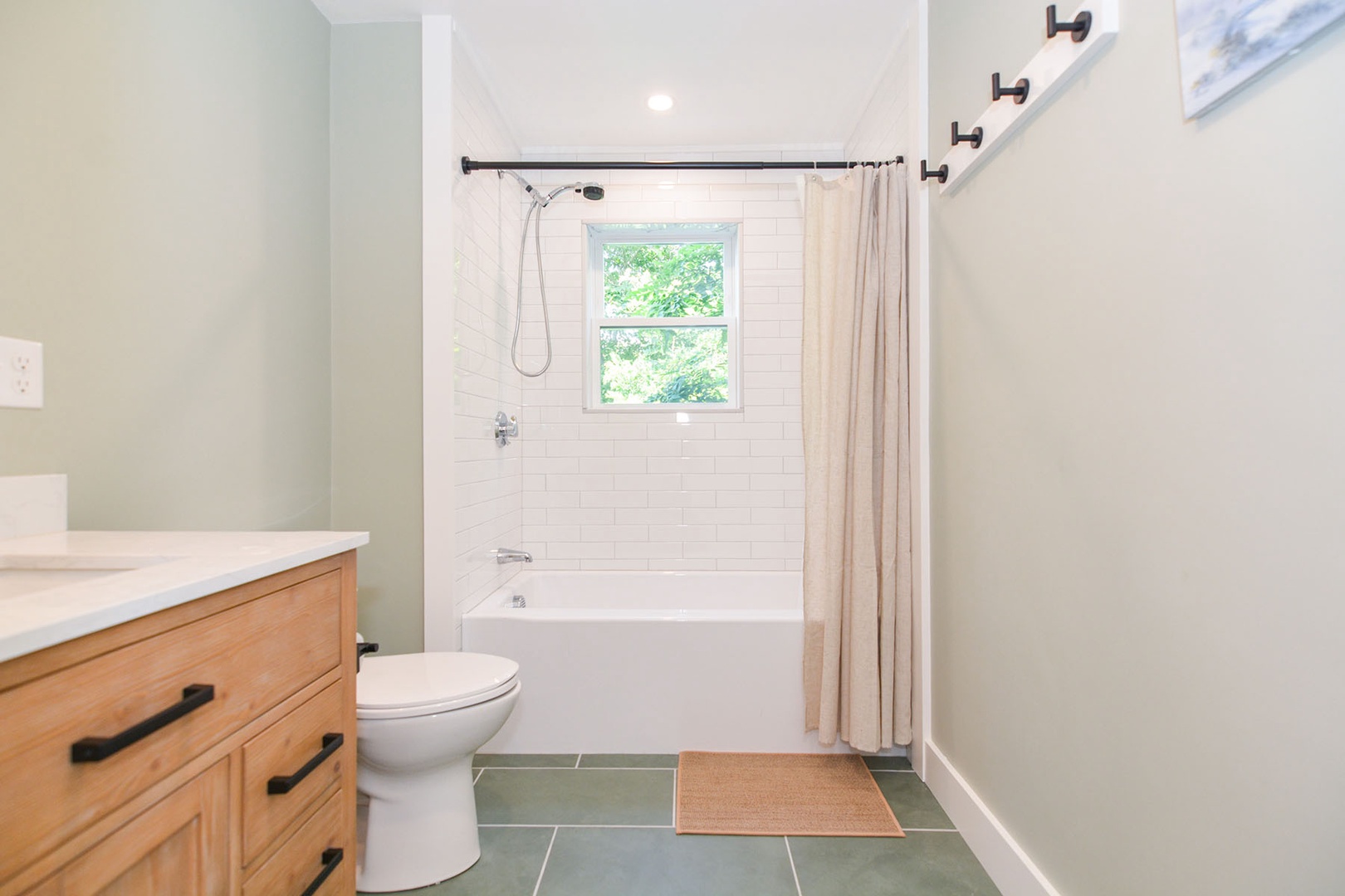 The full bathroom with a tub and shower combo.