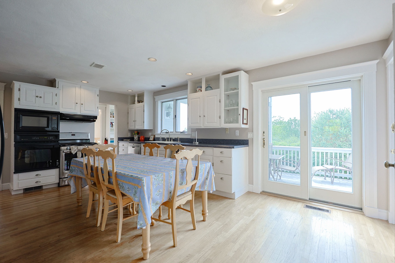 The bright eat-in kitchen has sliders out to the deck.