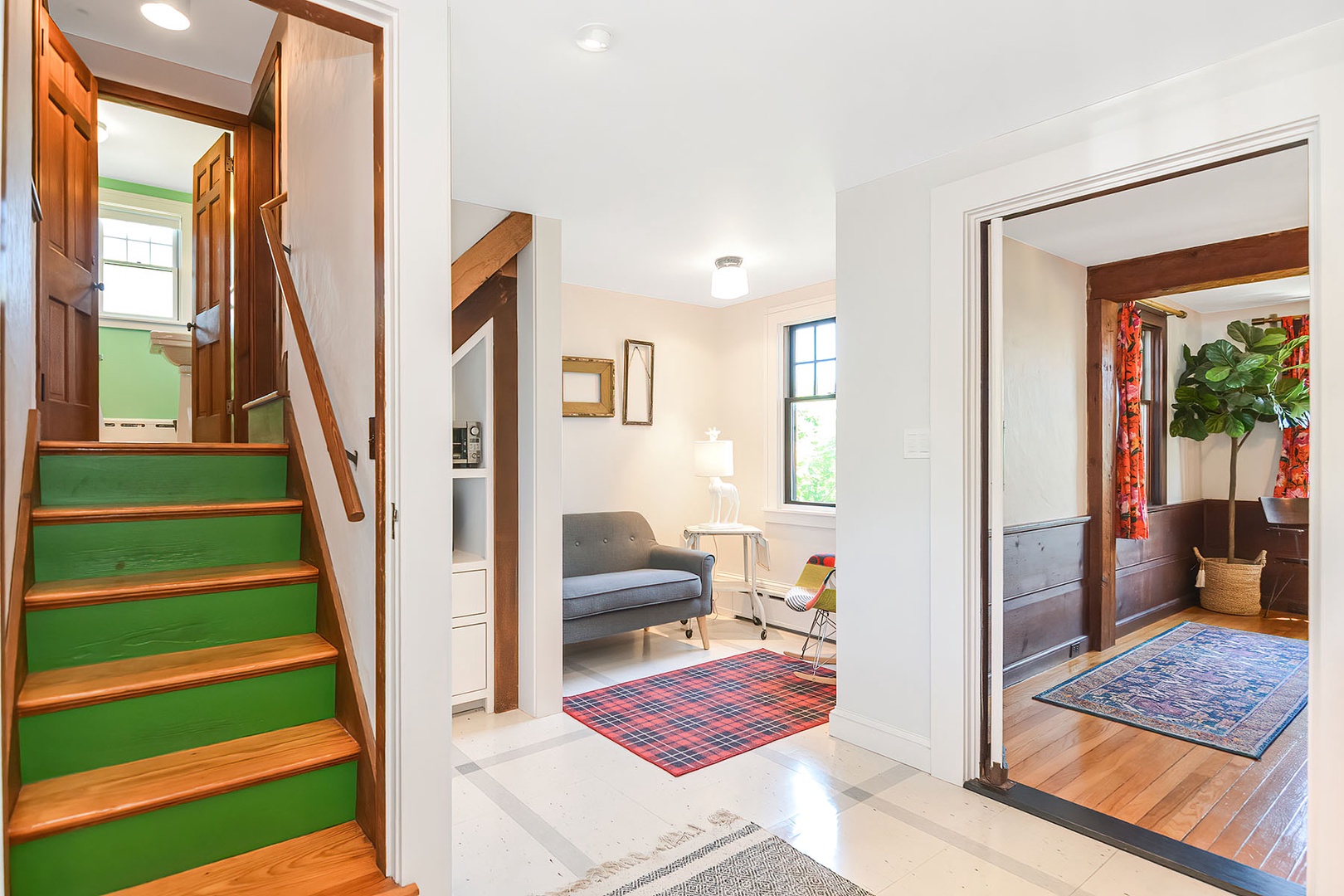A quiet sitting area off of the kitchen and stairs to the mezzanine level.