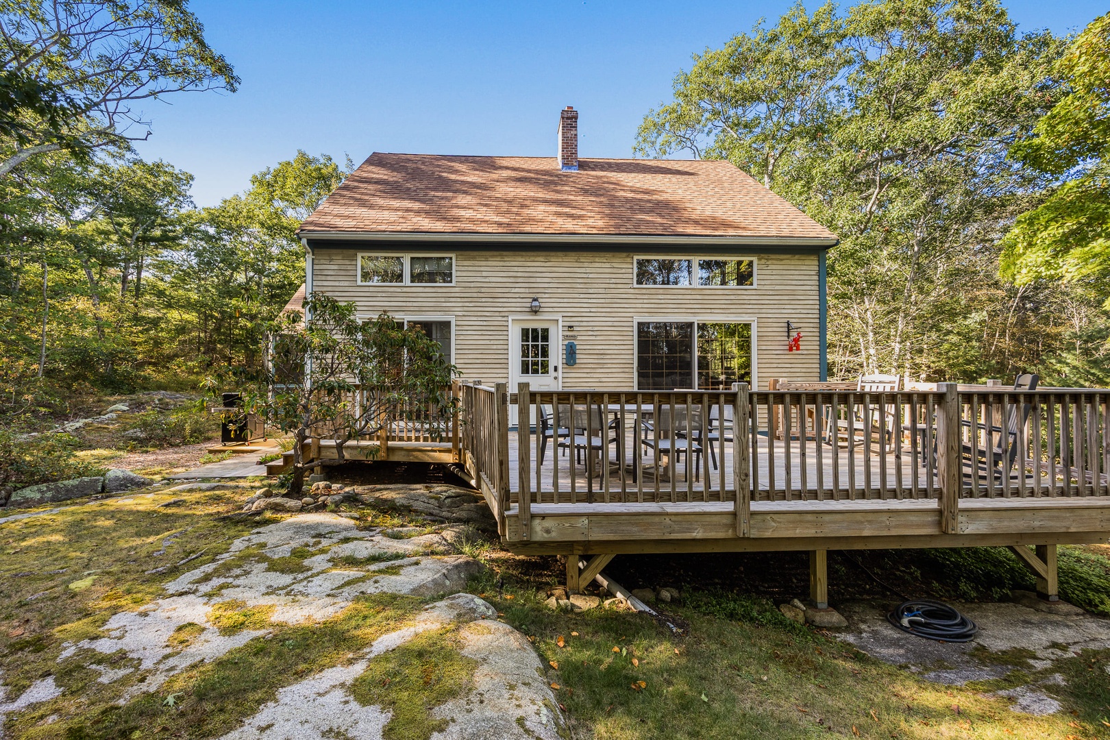 The house is nestled in a small forest.