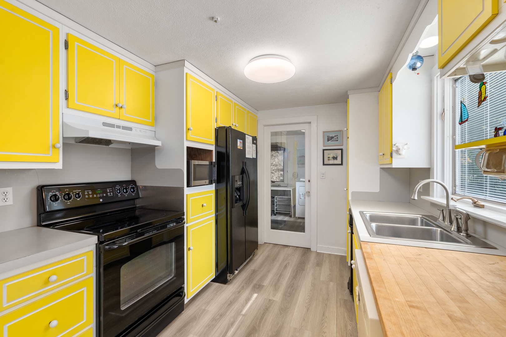 The kitchen includes all essential appliances and plenty of storage.