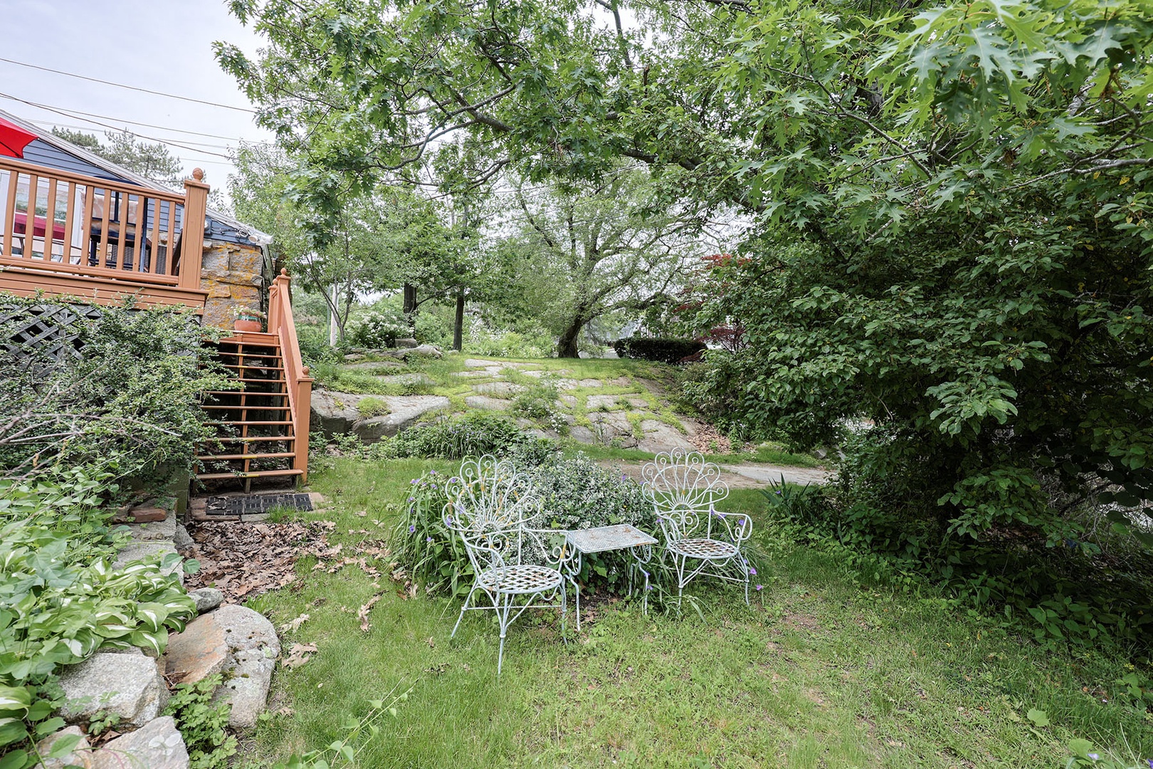Two cozy seats and a small table in the backyard