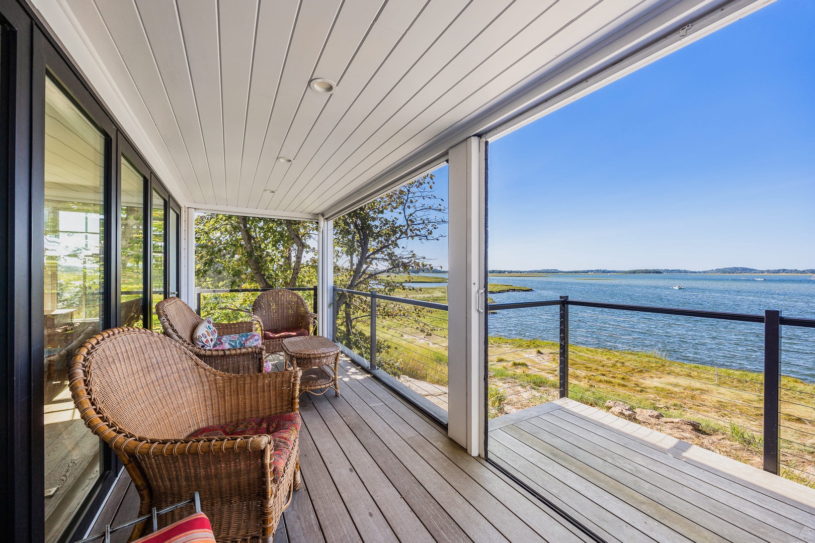 A cozy outdoor sitting area with views of tranquil waters.