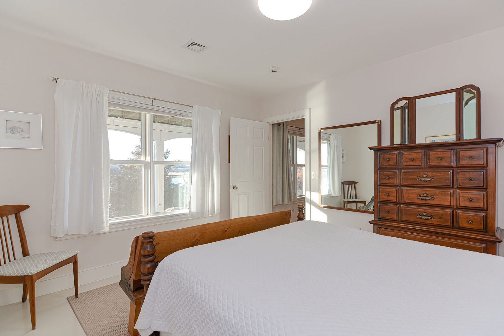Primary bedroom has views overlooking the river.
