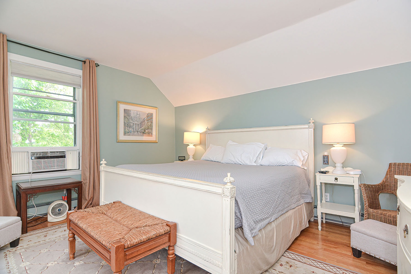 This bedroom has a King bed, flat screen TV and AC unit.