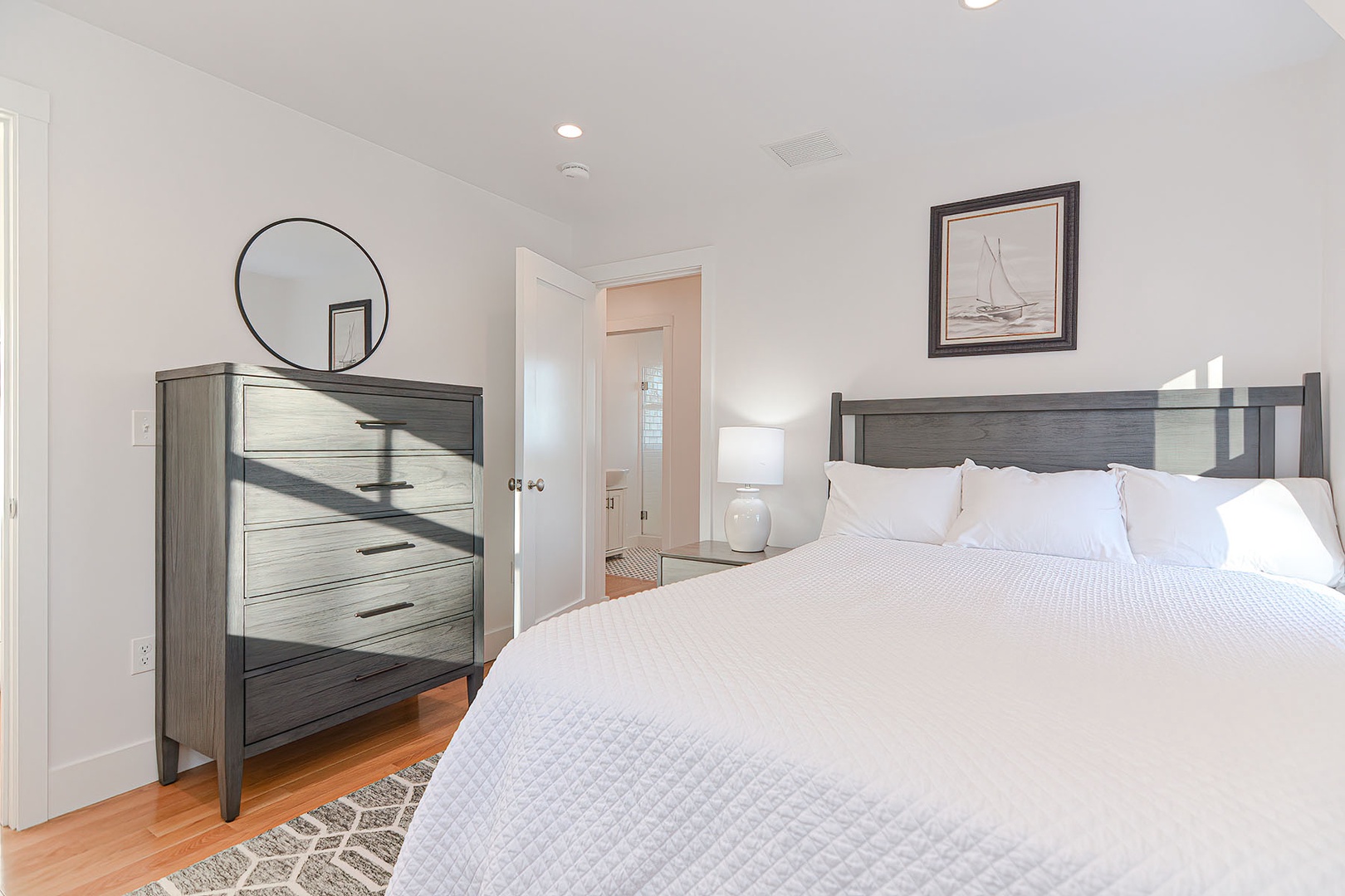 Bedroom with drawer and full size bed.