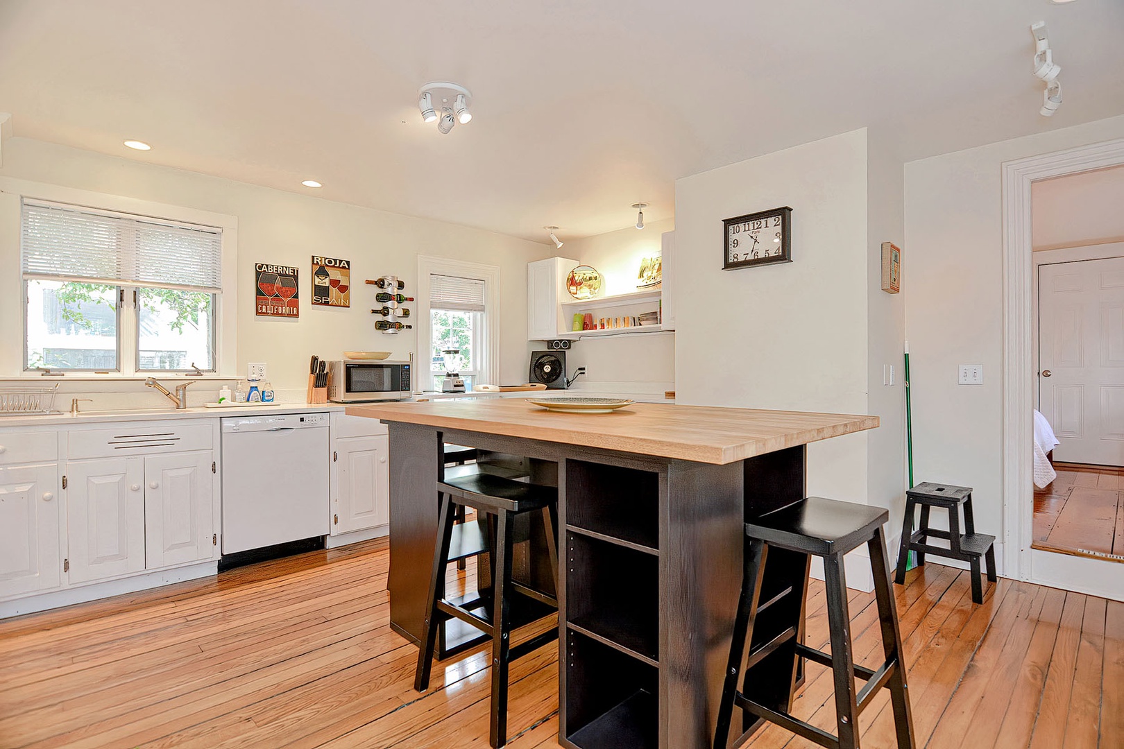 The main floor Queen bedroom is accessed via the kitchen.