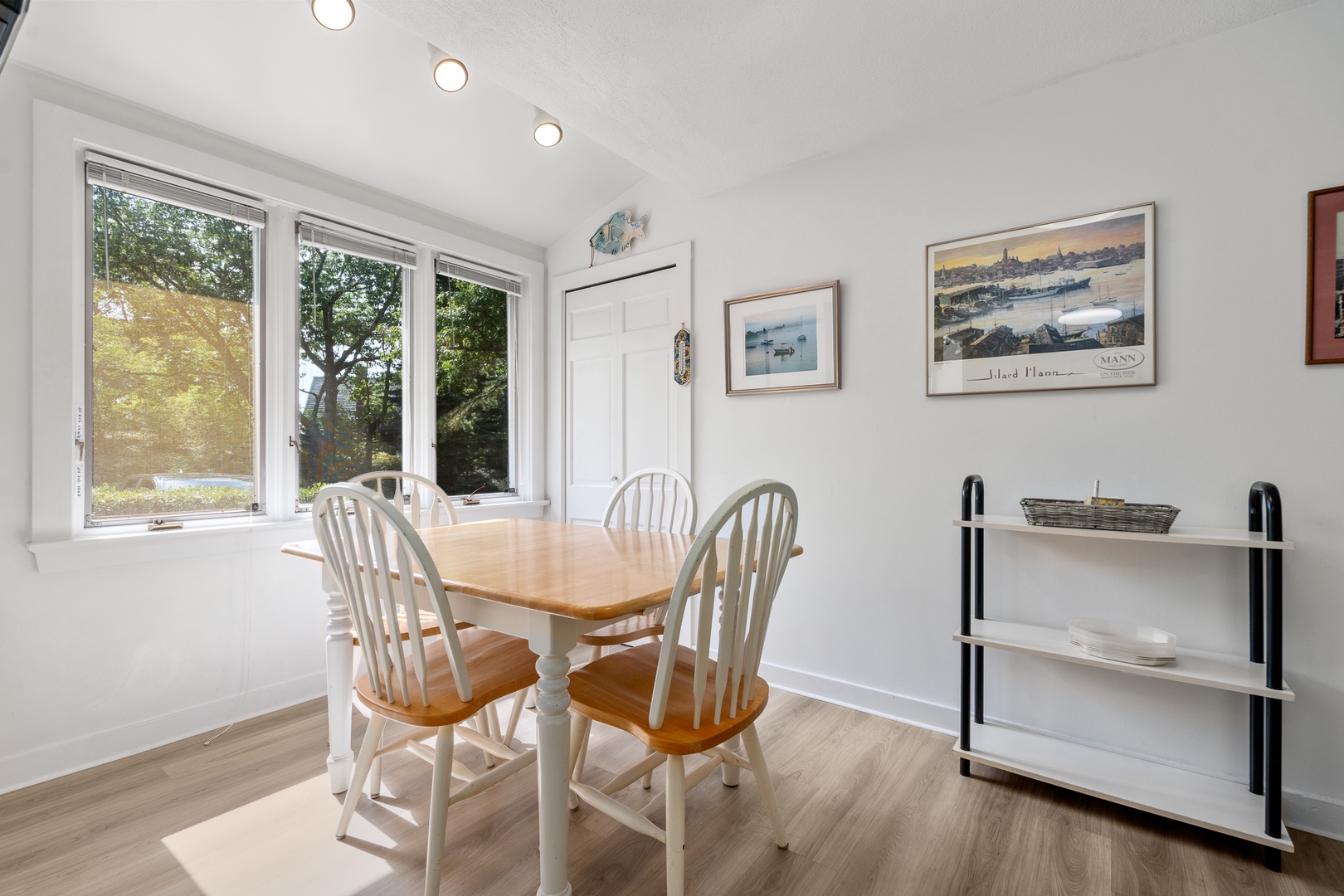 The in-kitchen dining area with natural lighting and views outside.