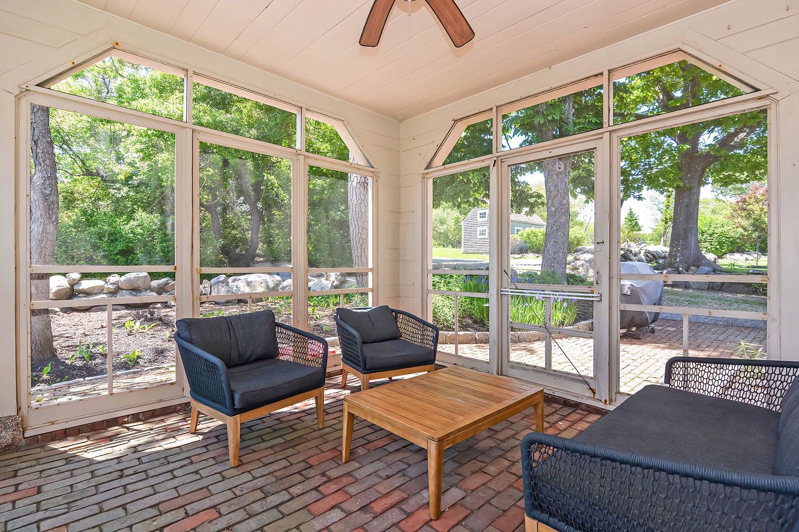 Screened porch with ocean views and ceiling fan.
