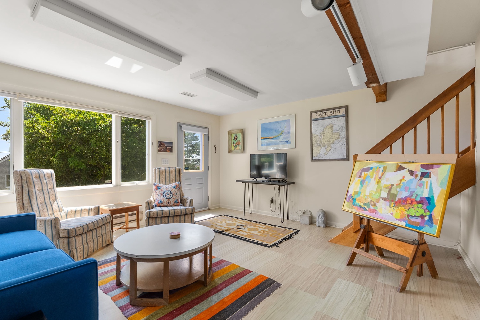 Ground level sitting room with flat screen tv.