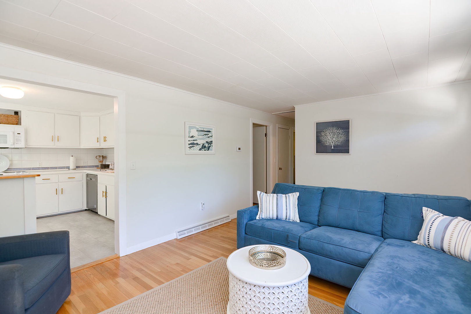 Spacious living room facing the kitchen.