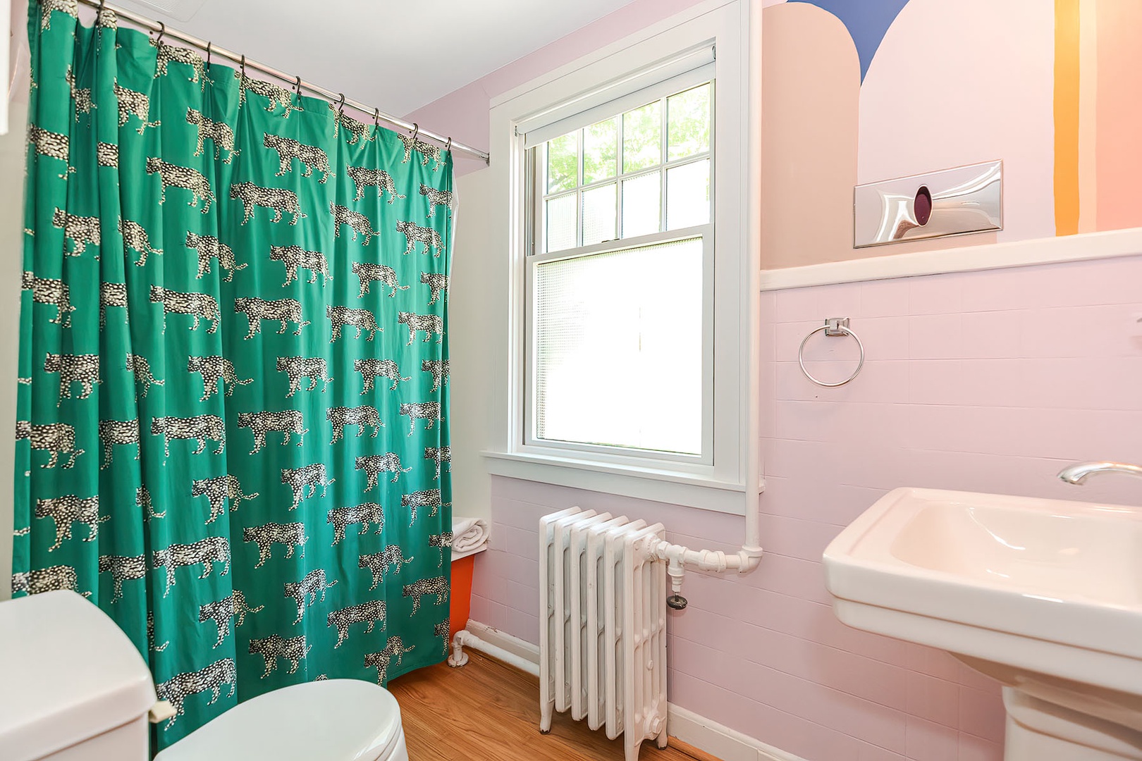 The bath has a fun zebra-striped curtain.