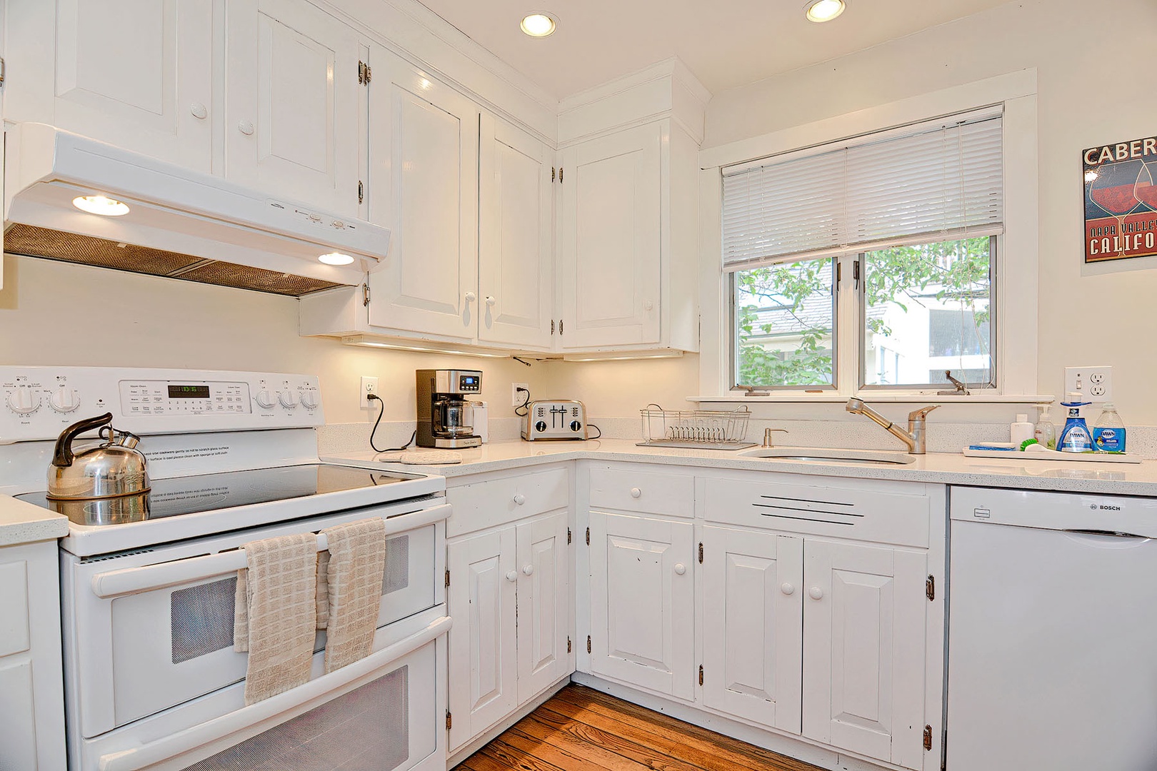 The kitchen includes an electric range and dishwasher.