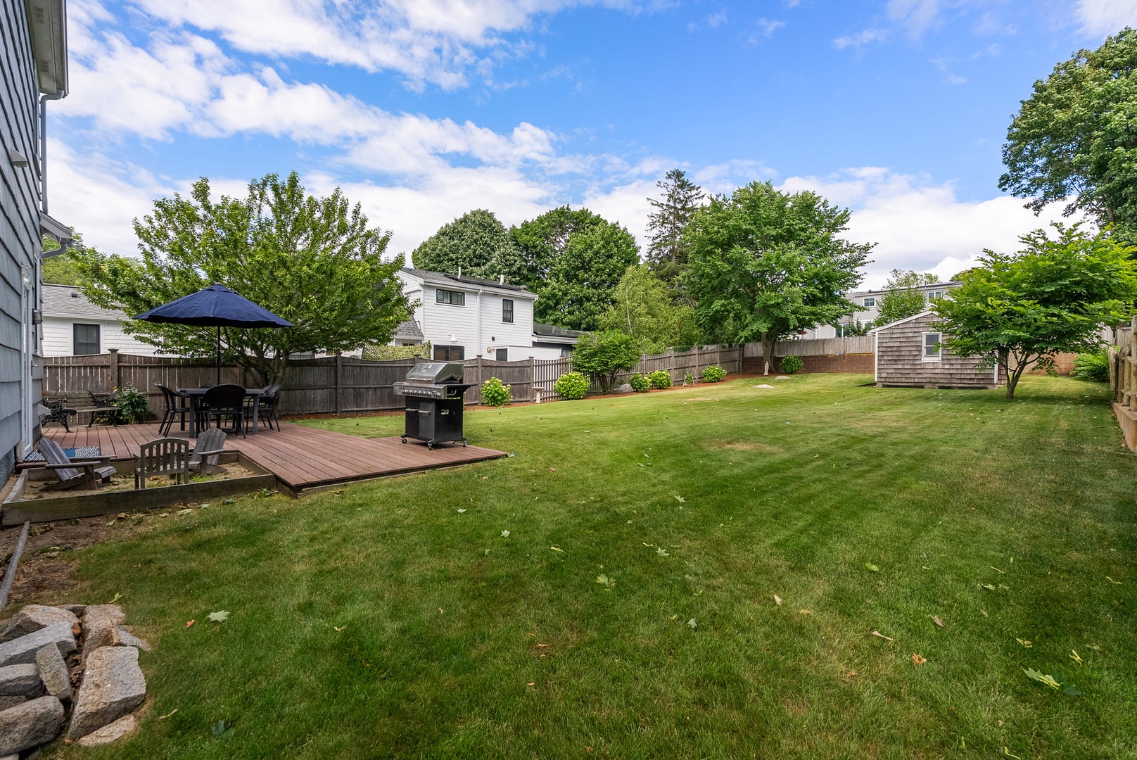 Beyond the patio is a large backyard.
