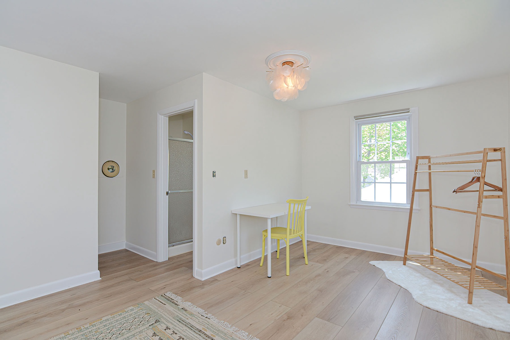 Desk and bathroom entrance in primary bedroom