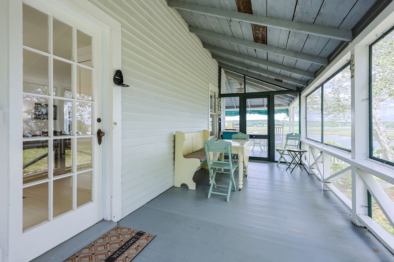 Spacious screened-in porch at the side of the house.