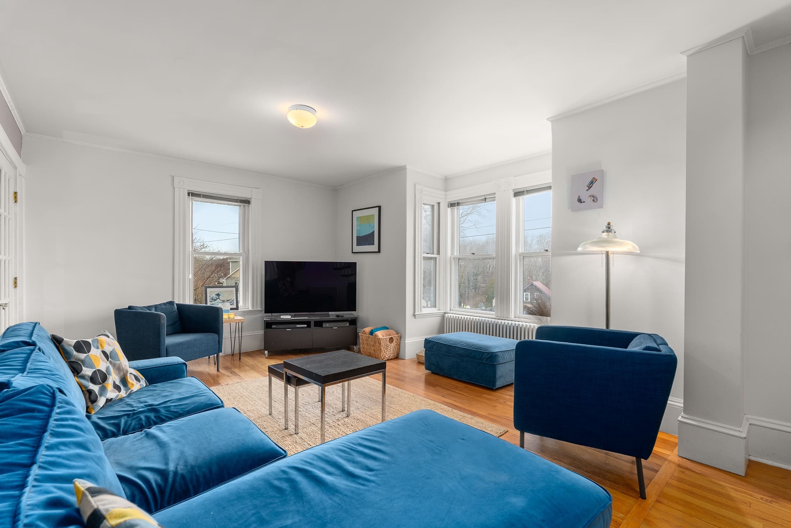 Spacious living room with natural lighting and comfortable seating.