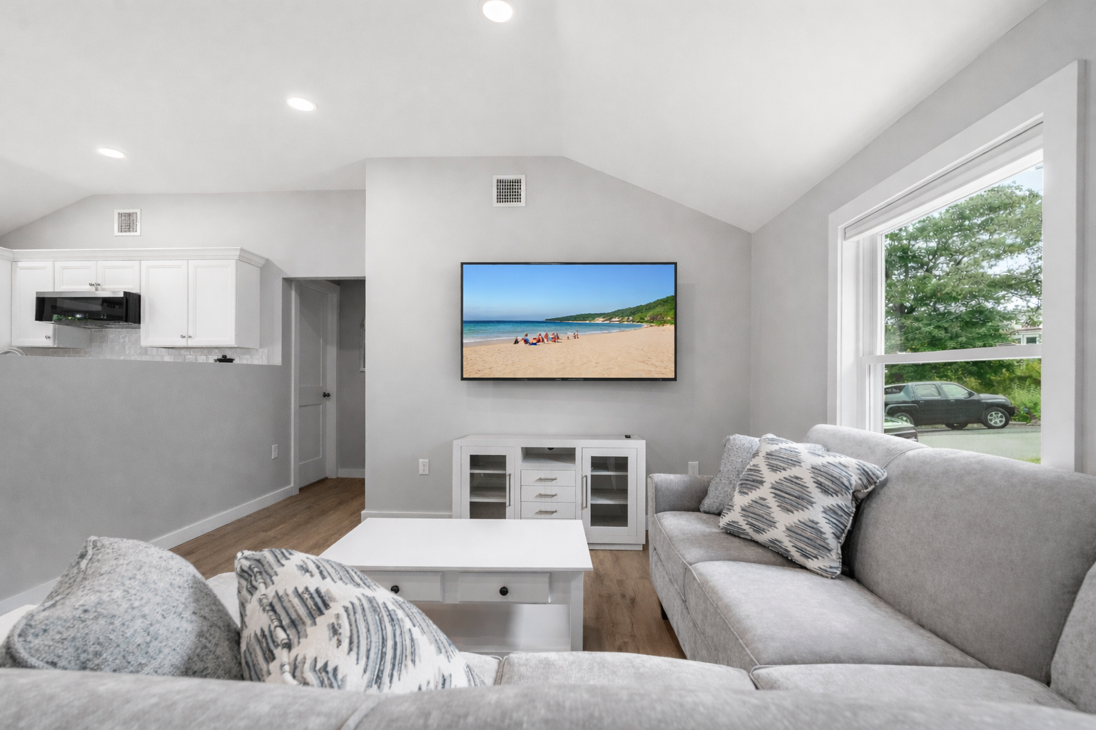 Spacious and comfortable living room with a TV.