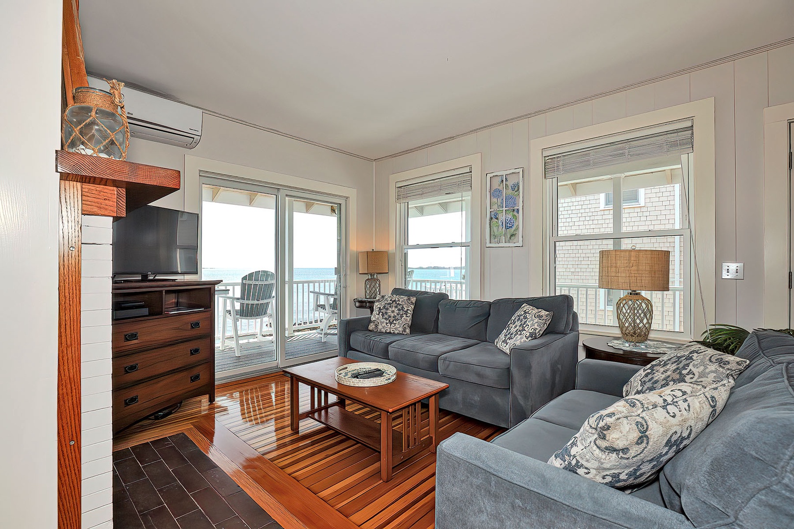 Gather in the living room to watch tv or watch the waves outside.