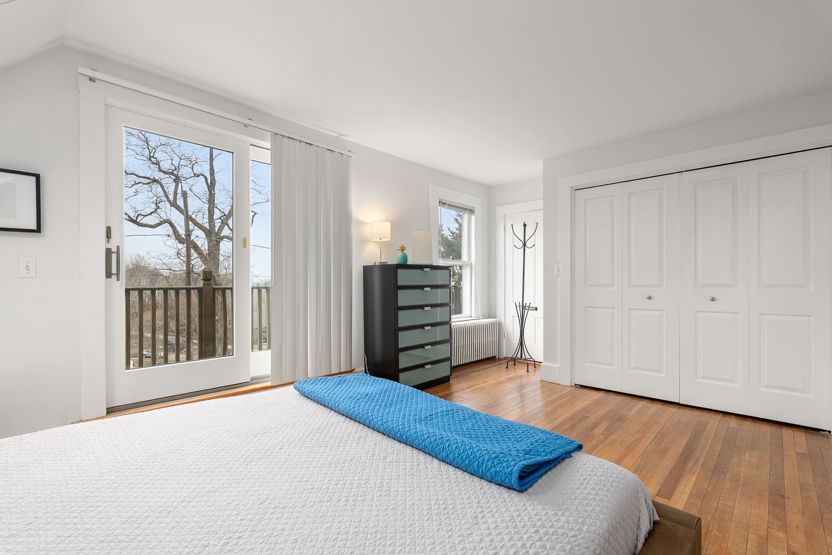 Primary bedroom includes sliders to a private deck.