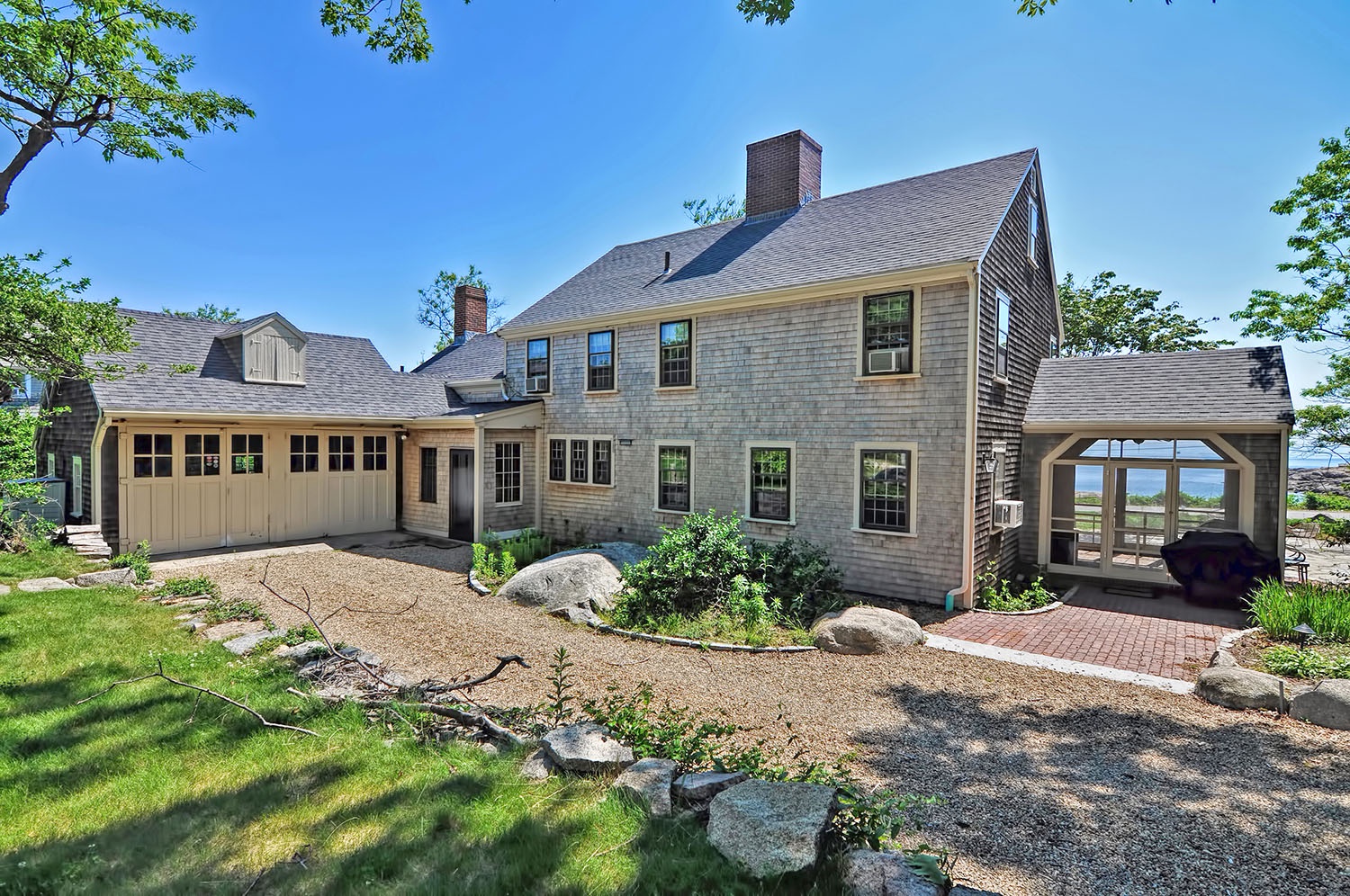 The rear exterior of the house and the driveway.