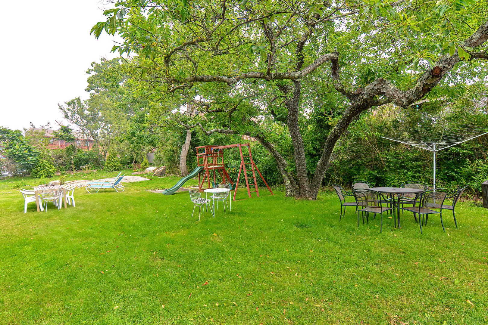 A large yard with a swing set.