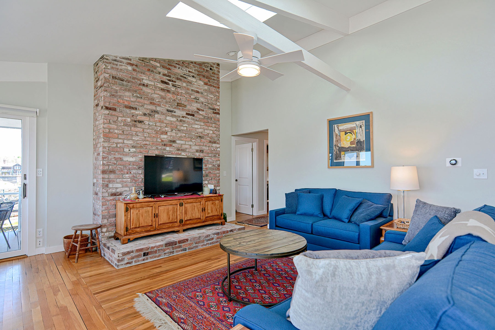 The large living and dining area has a cathedral ceiling and skylight.