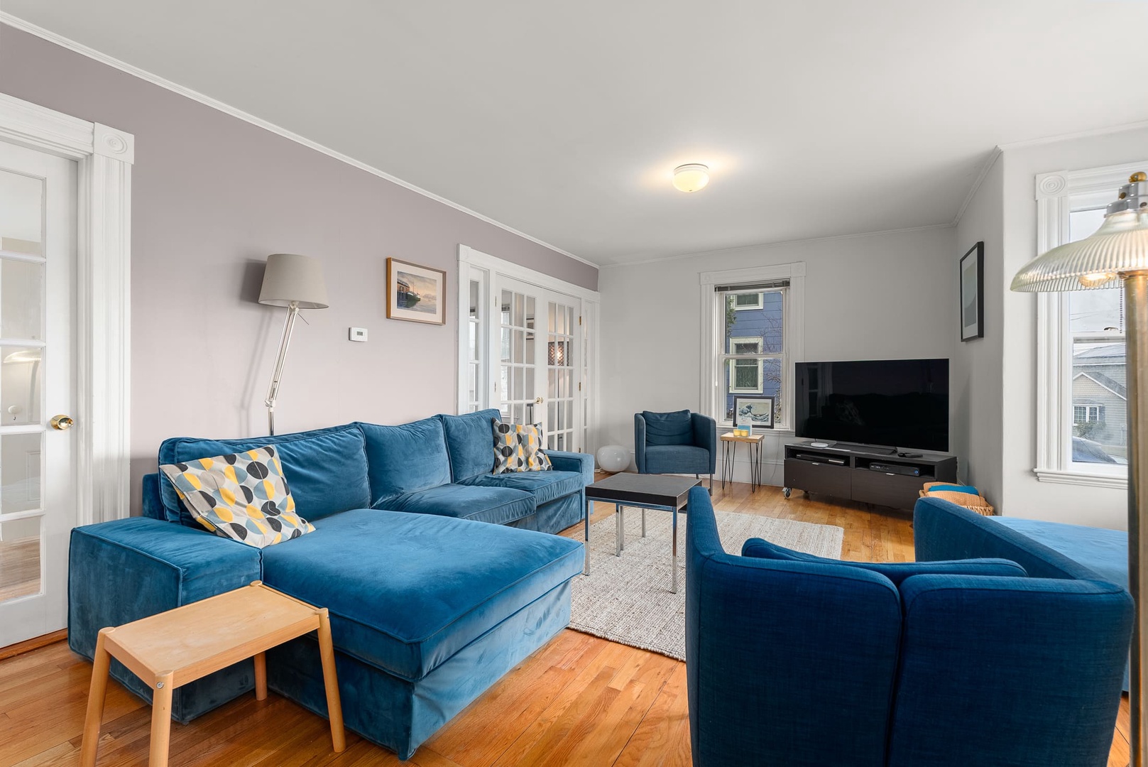 The living room includes a flat-screen tv and sectional sofa.