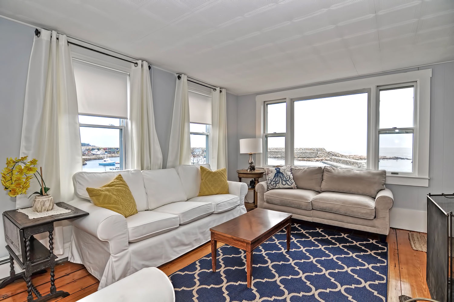 The living room has lovely views of Pigeon Cove.