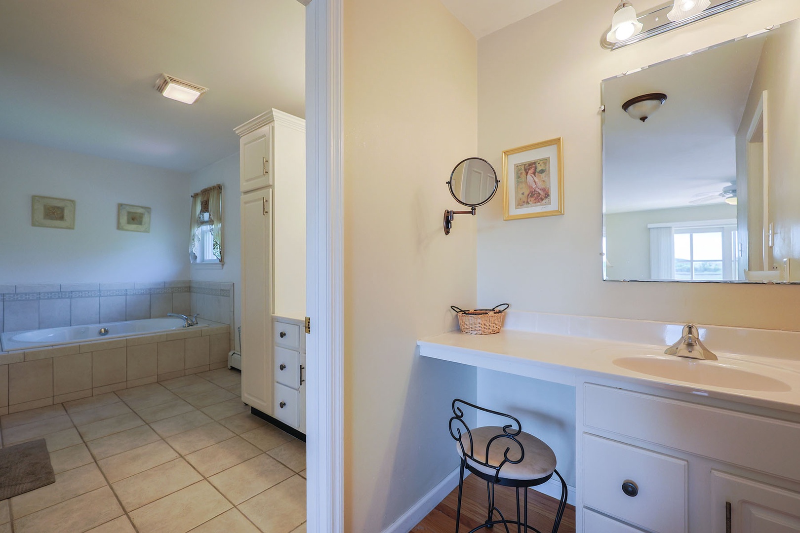 Ensuite primary bath with tub, walk-in shower, and a vanity counter