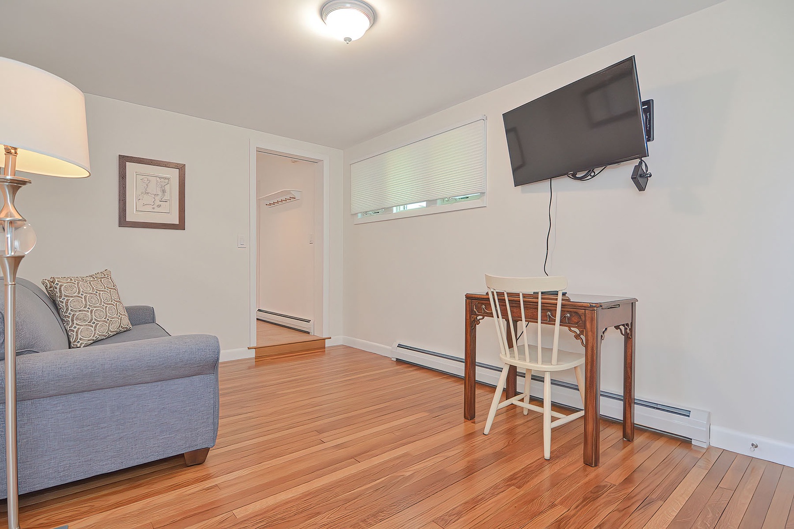 Wall-mounted flatscreen and a work area.