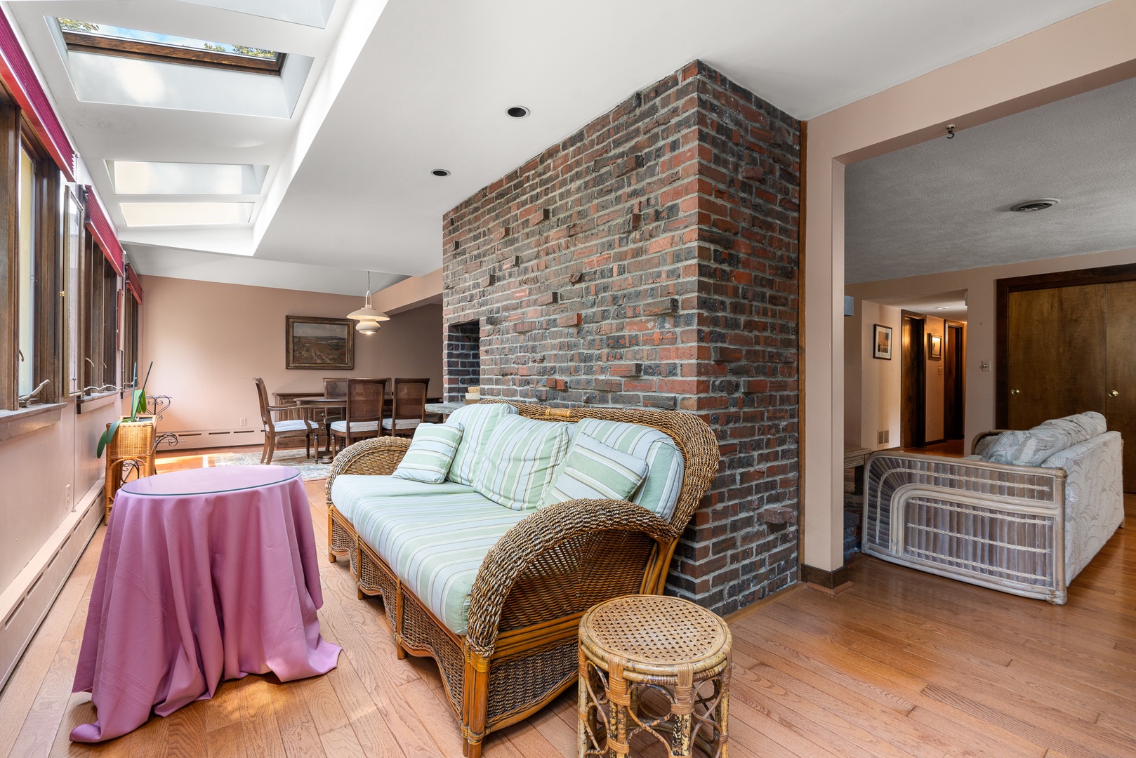 There's a space with a sofa and table opposite to the living room.