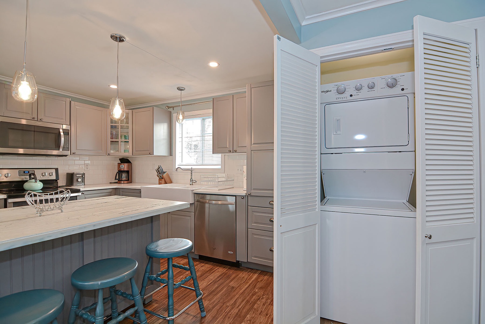 The laundry unit is tucked away in the closet in the kitchen.