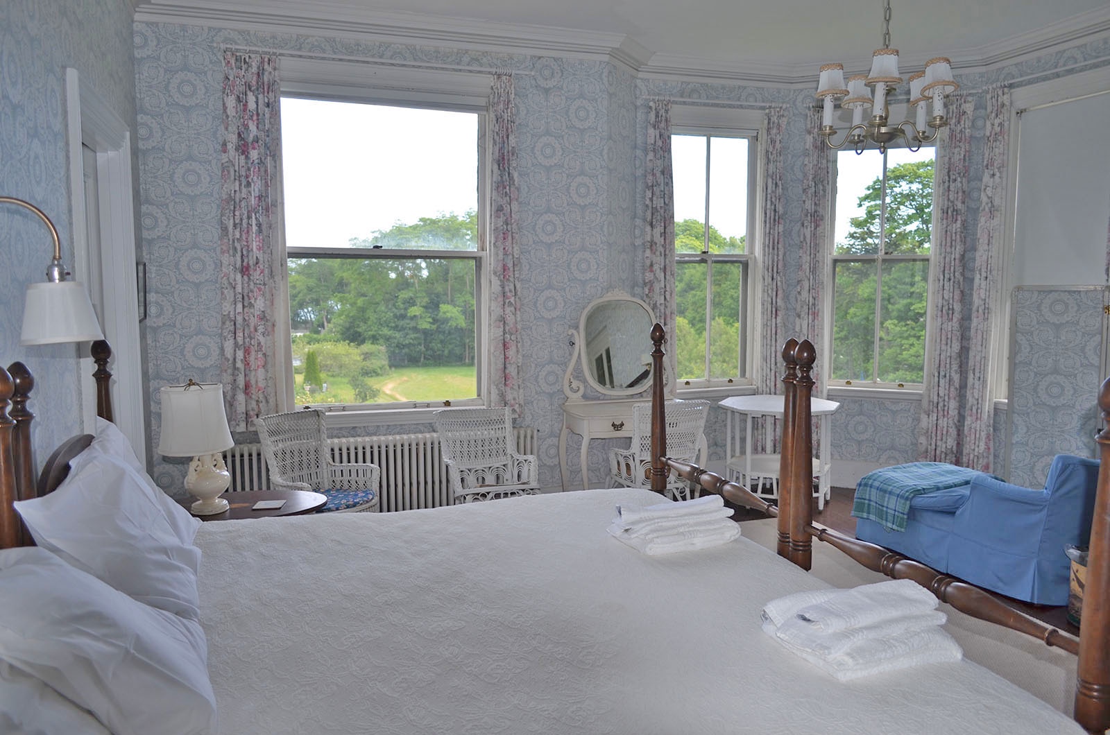Bedroom 1: The Primary bedroom has large windows and ocean views.