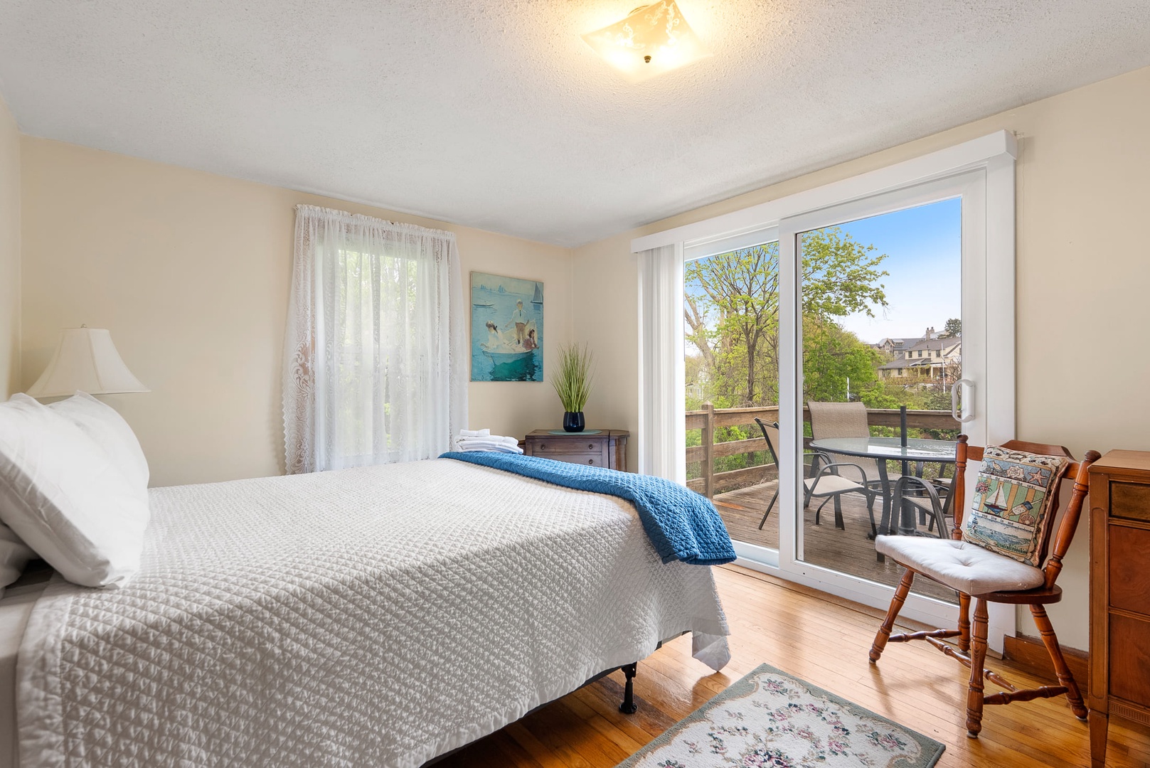 The primary bedroom with a queen bed and access to the deck.