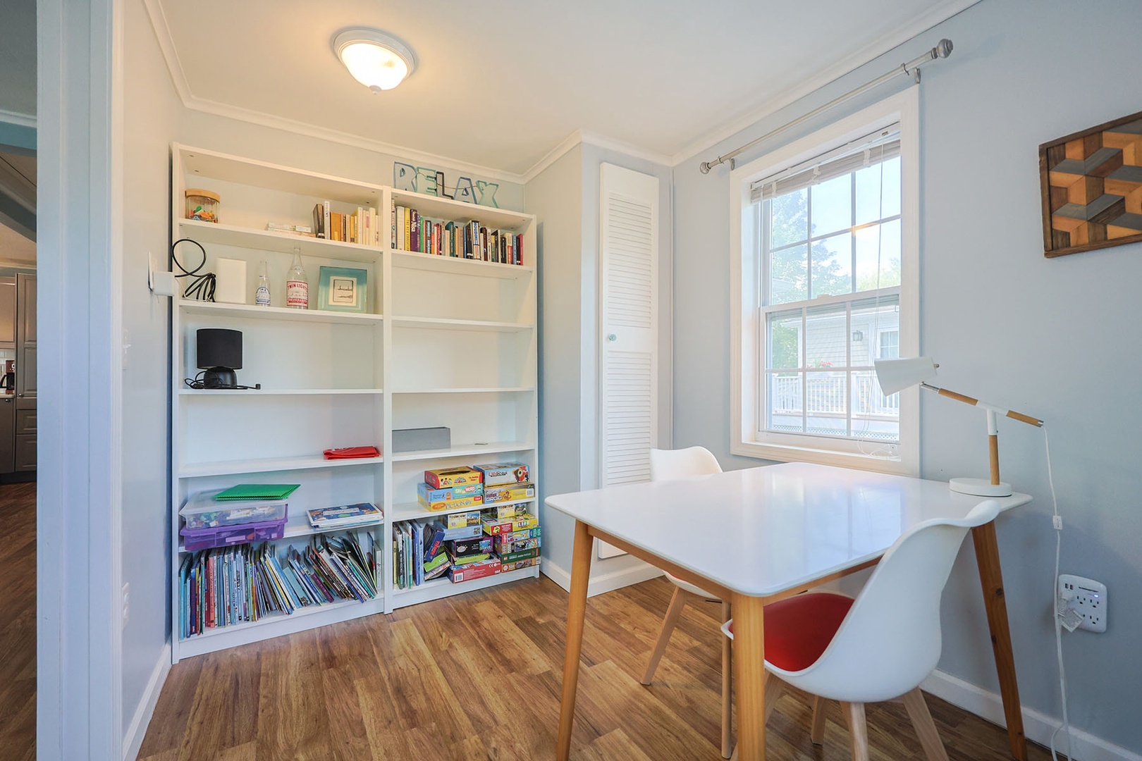 The study area has a bookshelf with books and games.