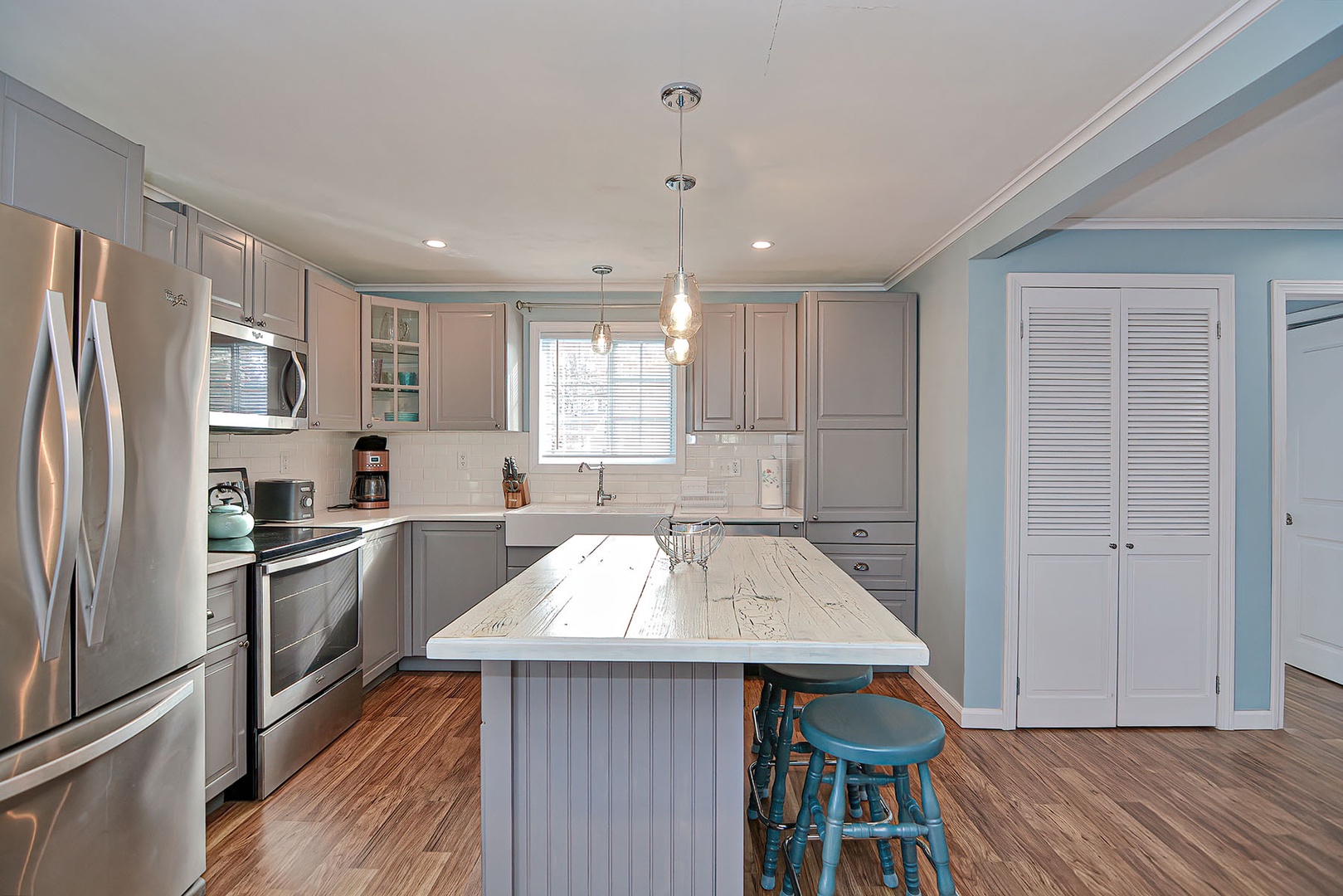 The updated kitchen with stainless steel appliances.