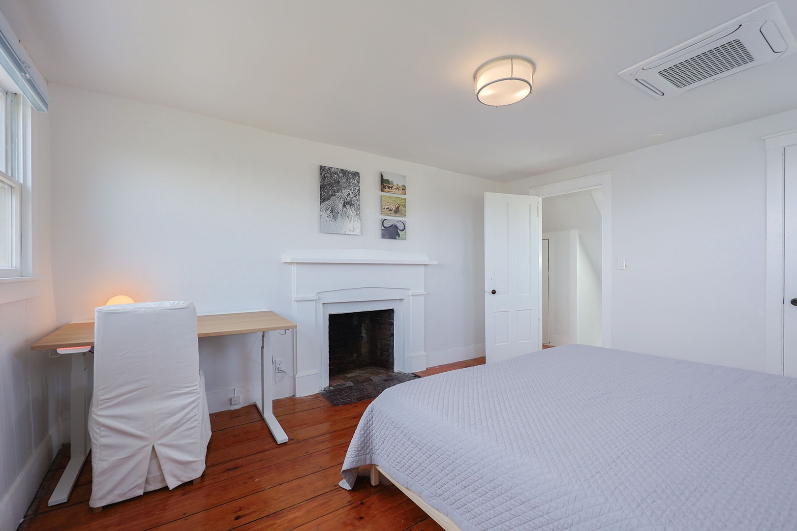 Bedroom 2 includes a workspace and an ornamental fireplace.