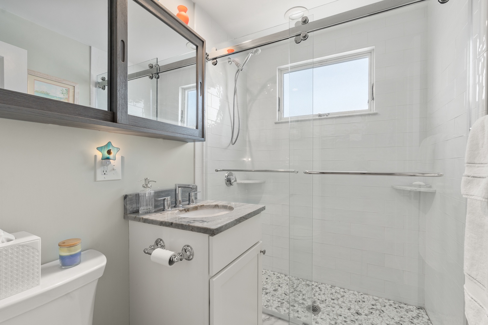 Full bathroom with a walk-in shower, located in the hall.