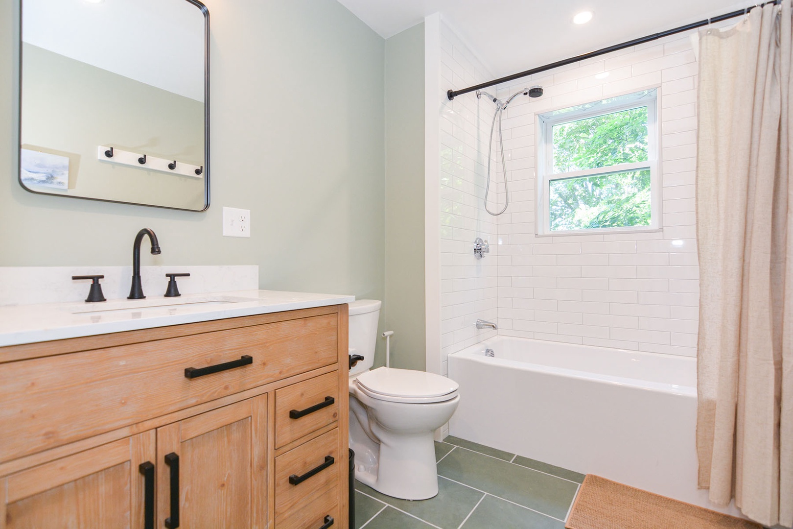 The full bathroom with a tub and shower combo.