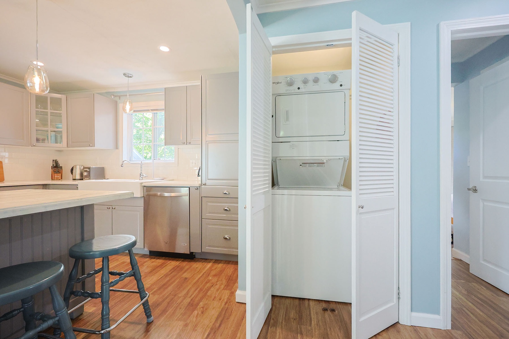 The washer and dryer are tucked away in a closet near the kitchen.