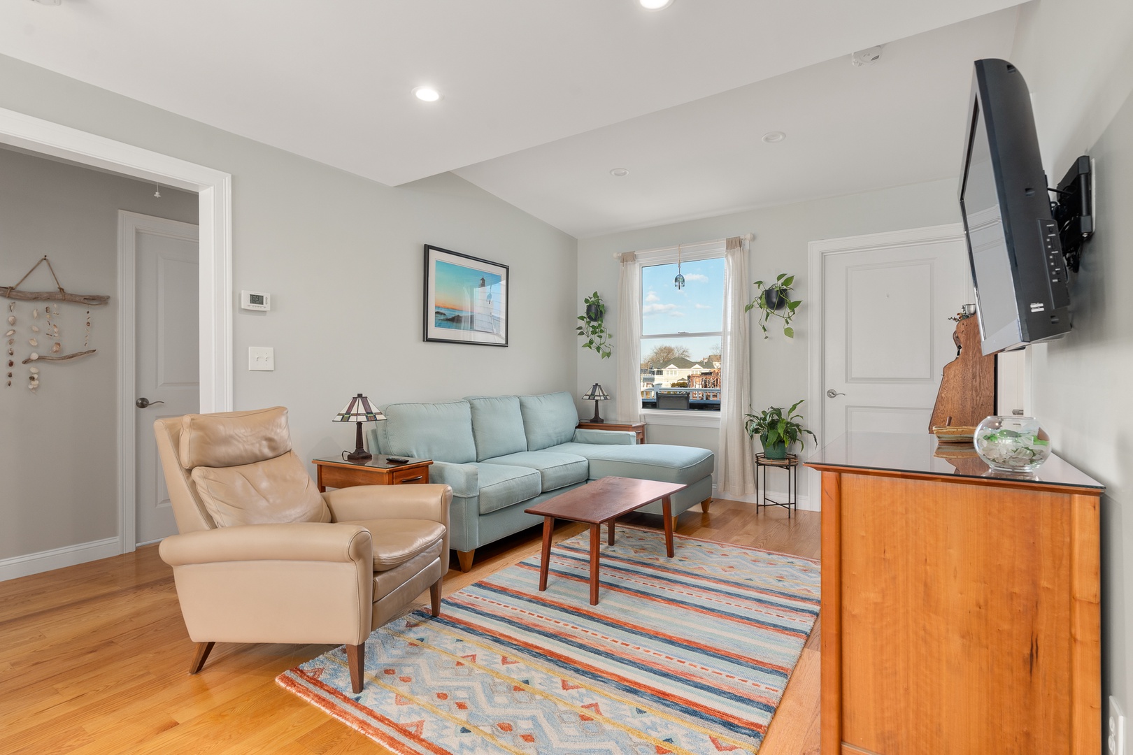 The living room is spacious and includes a flatscreen TV.