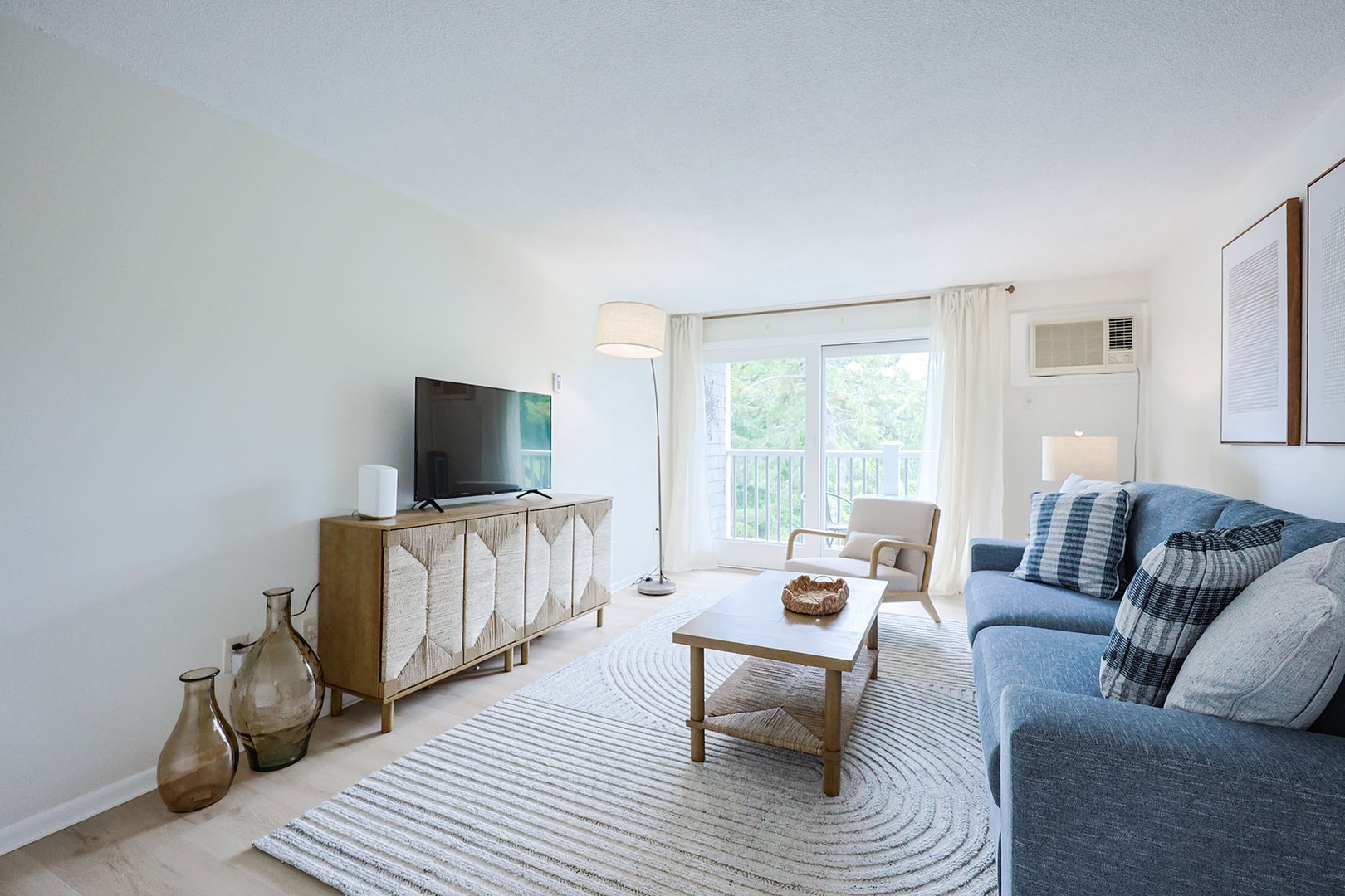 Cozy living room with a TV and plenty of natural lighting.
