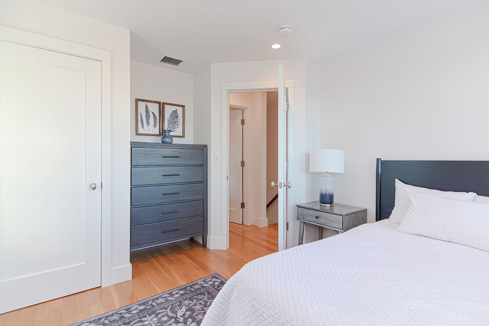 Bedroom with drawer and full size bed.
